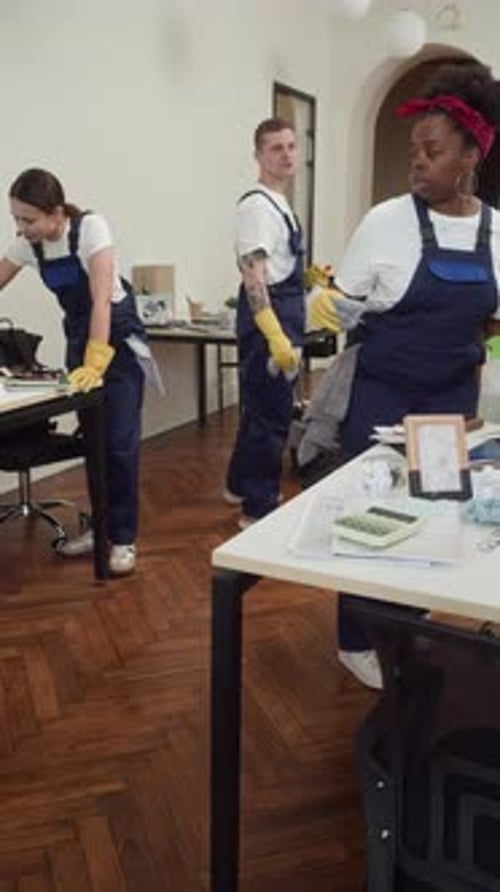 Cleaning Staff Sharing Duties Doing Cleanup in Office