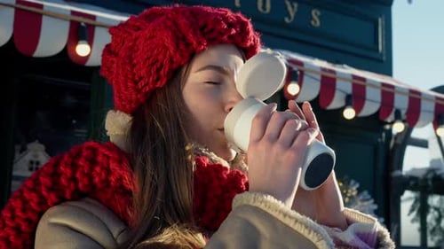 Woman Drinks Coffee on Sunny Winter Day