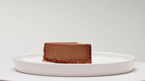 Delicious Chocolate Cheesecake Slice on White Plate