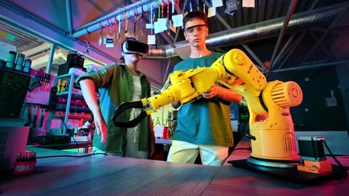Young Adults Controlling a Robotic Arm in Lab