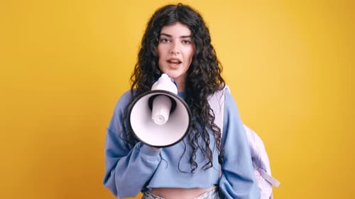Young Woman Speaking into Megaphone in Studio