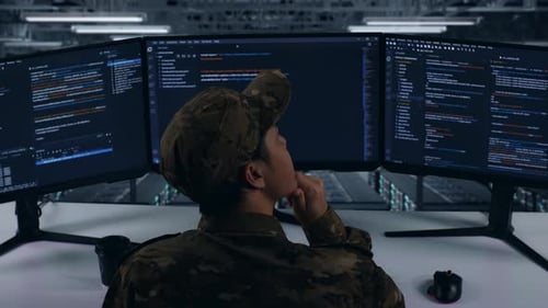 Asian Military Thinking Then Raising Index Finger While Write Code In Data Center