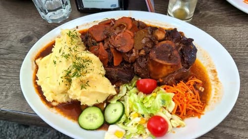 Huge portion of meat and mashed potatoes served in restaurant, close up