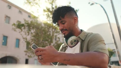 Young Adult Using Mobile Phone in Urban Setting