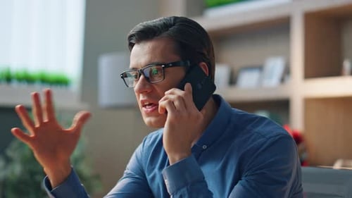 Stressed Man Disputing Telephone Call at Work Room Close Up. Nervous Businessman