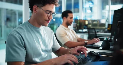 Computer, reading and typing with man at desk in office as programmer for software development