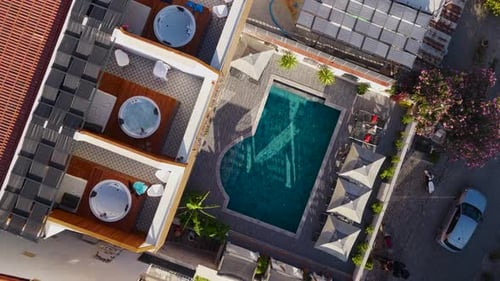Aerial Video of Woman Enjoying Quiet Swim in Hotel Pool