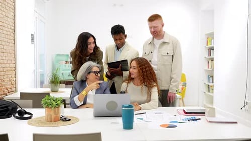 Diverse Creative Team Collaborating on Project in Modern Office