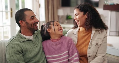 Happy Family Laughing Together on the Couch