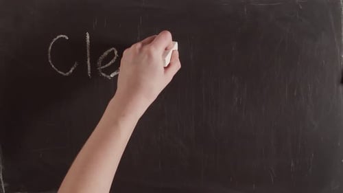 Hand Writes 'Clean Foods' on Chalkboard for Health