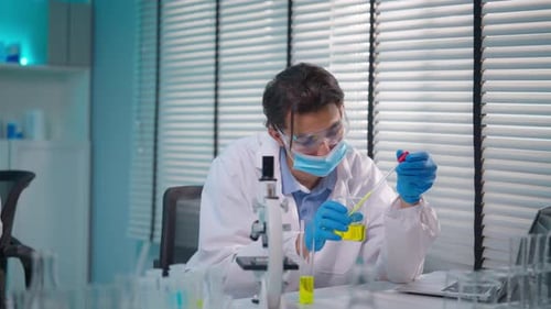 Asian male scientist working in the biotechnology research laboratory.