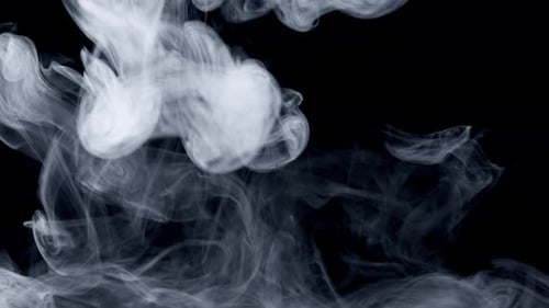 White Smoke Swirling on Black Background