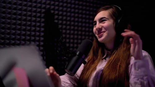 Young Woman Voice Acting in Recording Booth