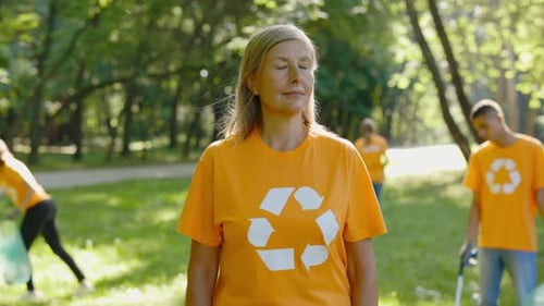 Portrait Of Young Caucasian Woman Volunteer Wearing TShirt With Recycling Symbol On It Looking To