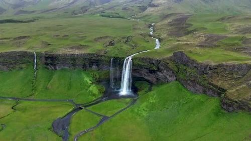 Majestic Seljalandsfoss Waterfall Cascading Down Lush Green Cliffs in Icelands Highlands