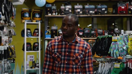 Man Walking Through Power Tool Store Aisle
