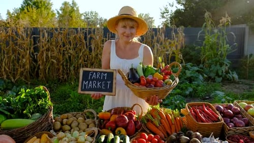 Woman at a Farmers Market with Vegetables Selective Focus