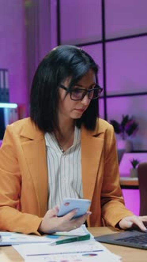 Workflow in Office Where Goodlooking Successful Responsible Experienced Brunette in Trendy Orange