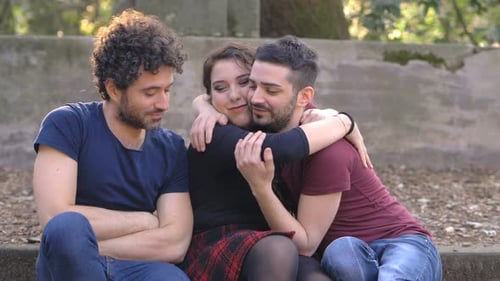 Two Men Embracing Woman in Park