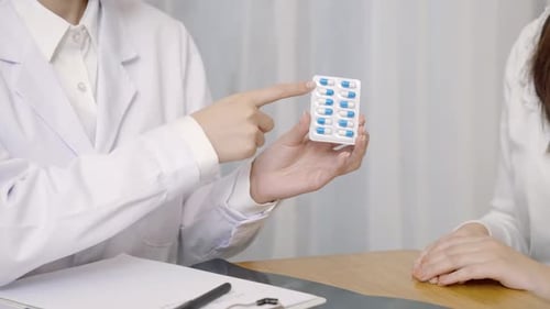 Doctor Explains Medication to Patient in Medical Office