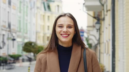Closeup Young Smiling Woman Looking at Camera in City