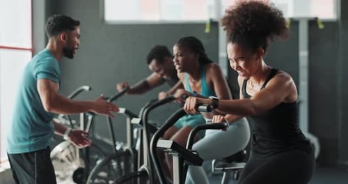 Coach, gym or people on cycling machine for a biking workout or cardio training for endurance