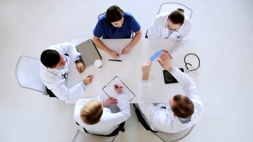 Medical Team Meeting at Table in Clinic, Bird's Eye