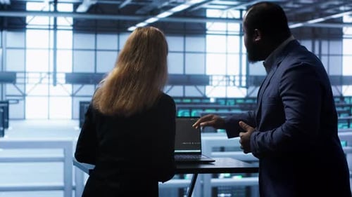 Team of Engineers in Data Center Doing Brainstorming to Fix Problems