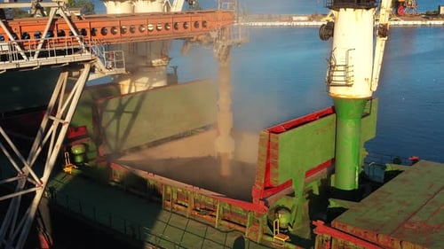 Aerial of Wheat Loading to Bulker Ship Cargo Hold at Sea Grain Elevator in Sea Port Wheat Shipment