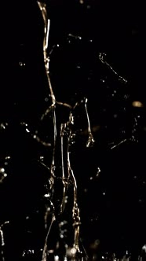 Gold Liquid Splashing Upward in Abstract Pattern