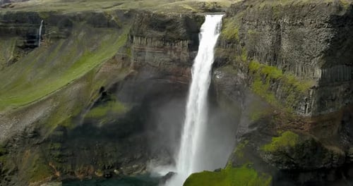 Aerial view of Large waterfall with green landscape in Iceland