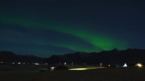 Northern Lights or Aurora Borealis Real Time Lapse with Stars and Clouds Over Icelandic Night Sky