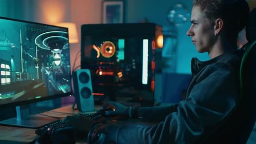 Young Man Plays Video Game at Home at Night