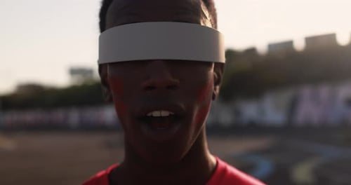 Man Smiling with Visor and Red Face Paint