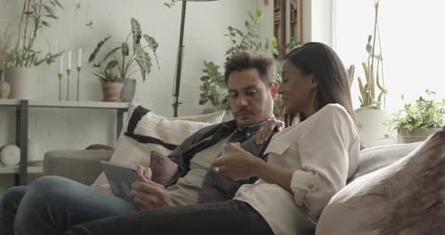 Couple Relaxing Together on Couch with Tablet