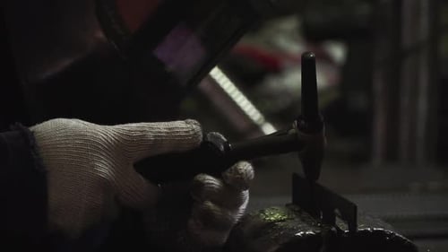 Welder Welding Metal with Protective Gear and Sparks