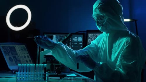 Researcher in Hazmat Suit Works in Lab