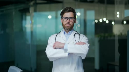 Confident Doctor with Stethoscope Stands in Modern Office