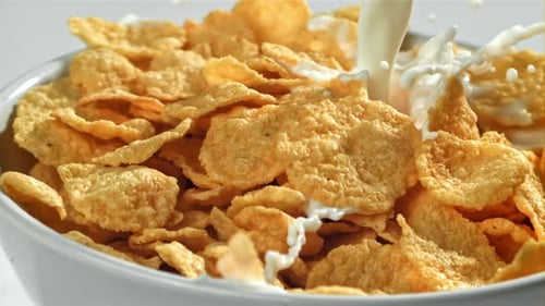 Pouring Fresh Milk Over Crispy Corn Flakes