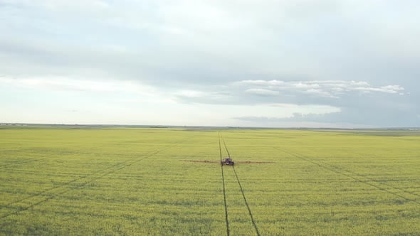Farm Machinery Applying Insecticide On Beautiful Vibrant Yellow Canola ...