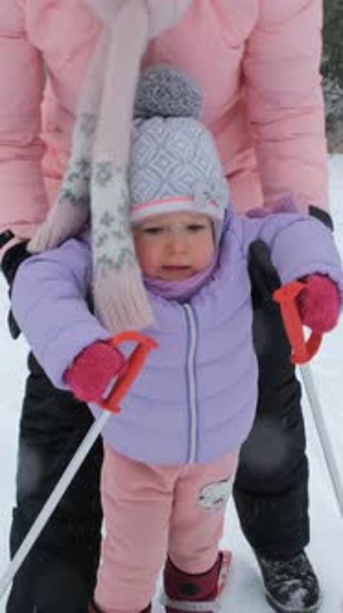 Child Learning to Ski in Snowy Winter Landscape