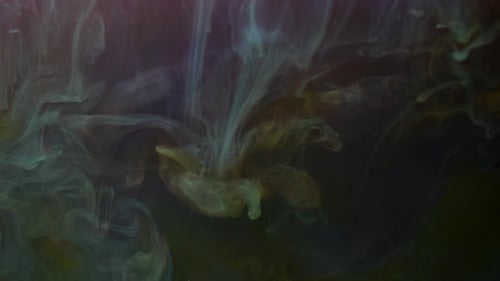 Flowing Greenish-Yellow Ink in Dark Liquid