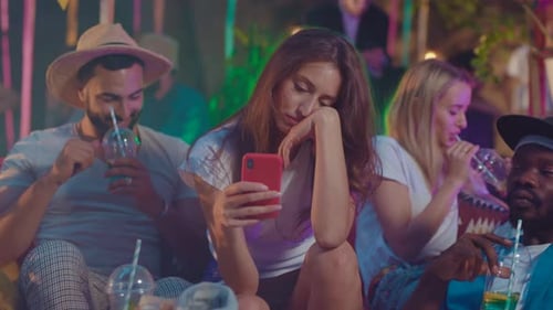 People drinking cocktails at night