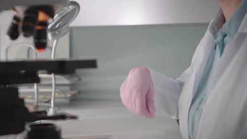 Dedicated Scientist Analyzing Sample with a Microscope