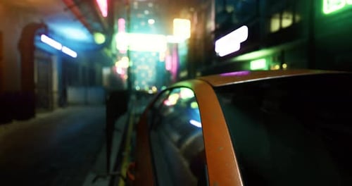 Urban Nightlife Illuminated By Neon Lights in a Bustling City Street