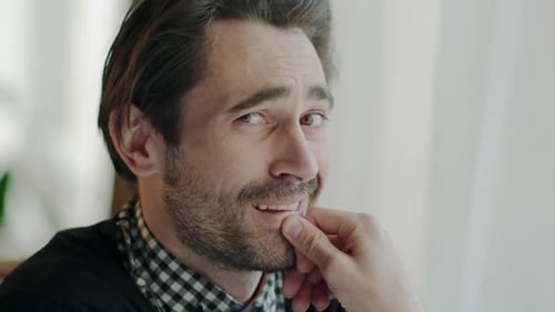 Thoughtful Man Smiles and Looks Around