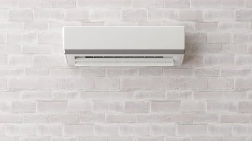 Modern air conditioner hanging on the wall in room. Cooling product for hot climate in summer.