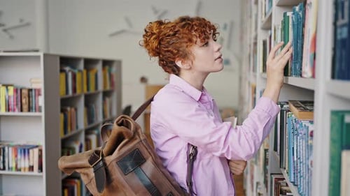 Young Woman Browsing Books in a Library