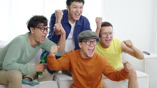 Friends Watching and Cheering at Home Together