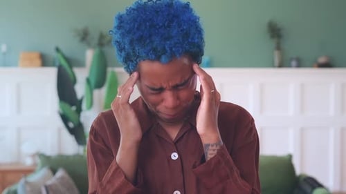 Woman Rubbing Temples Suffering From Headache